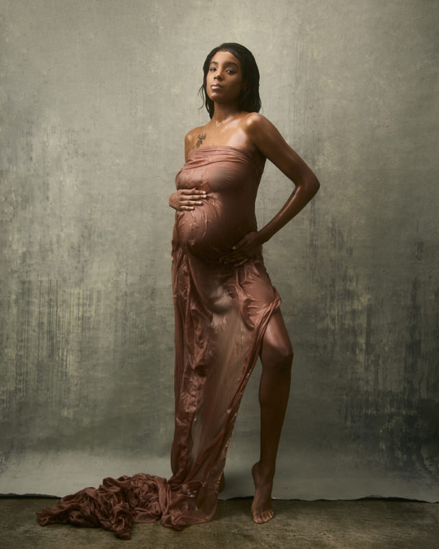 Elegant pregnant woman in flowing fabric.